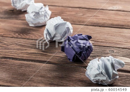 Concept of creativity and inspiration presented by white paperballs and one color 60054549