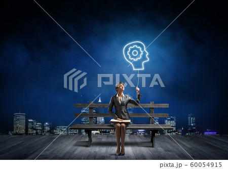 Young woman holding open book on bench 60054915