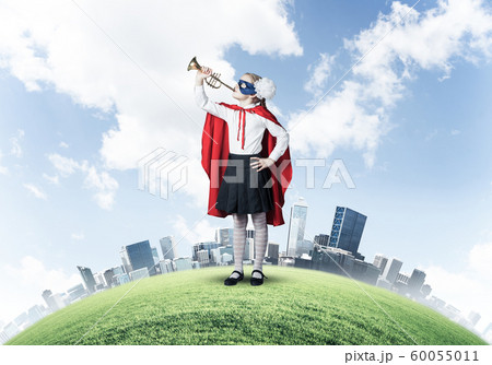 Girl power concept with cute kid guardian against cityscape background Girl power concept with cute kid guardian against cityscape background 60055011