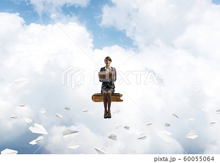 Smiling woman holding open book Smiling woman holding open book 60055064