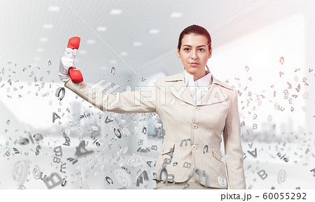 Woman keep at distance vintage red phone 60055292