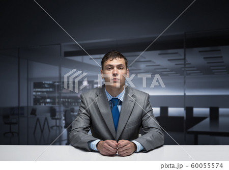 Young man folded hands and having serious face Young man folded hands and having serious face 60055574