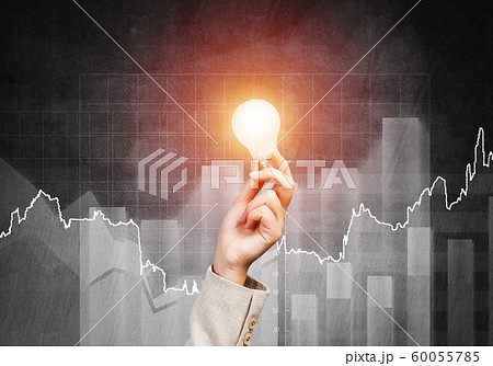 Woman hand with glowing incandescent lamp 60055785