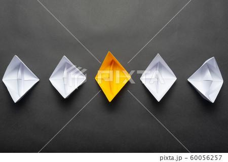 Row of paper ships on black background 60056257