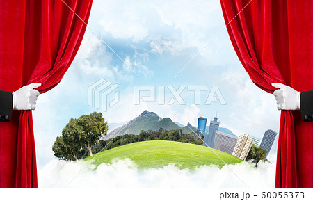 Modern cityscape behind drapery curtain and hand opening it Modern cityscape behind drapery curtain and hand opening it 60056373
