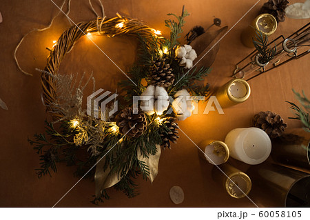 top view of florist hands making Christmas wreath with fir branches and led light. Top view, zero 60058105