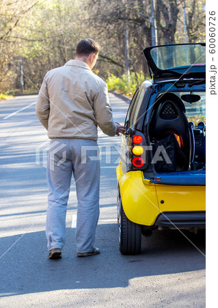 Man by his car waits for help Man by his car waits for help 60060726