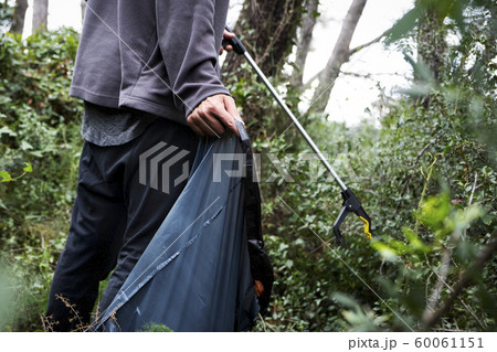 man collecting garbage in the forest man collecting garbage in the forest 60061151