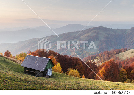 Picturesque autumn meadow with wooden house Picturesque autumn meadow with wooden house 60062738