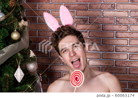 Handsome naked guy in suit rabbit celebrating 60063174