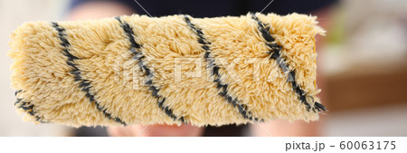 Arm of smiling worker hold brush closeup 60063175