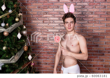 Handsome naked guy in suit rabbit celebrating 60063181