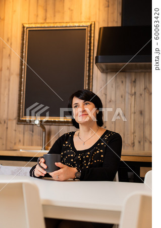 A beautiful woman of 50 years old is sitting in A beautiful woman of 50 years old is sitting in 60063420