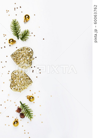 Merry Christmas and Happy Holidays greeting card, frame, banner. New Year. Noel. Christmas gold decor on white background top view. Winter xmas holiday theme. Flat lay 60063762