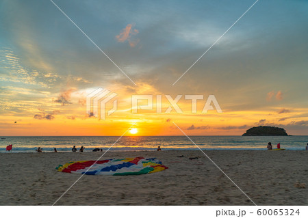 parasail on the beach in sunset 60065324