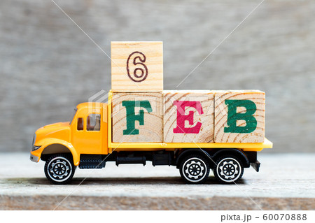 Truck hold letter block in word 6feb on wood background Truck hold letter block in word 6feb on wood background 60070888
