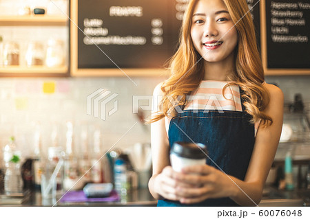 Portrait young Asian woman barista feeling happy 60076048