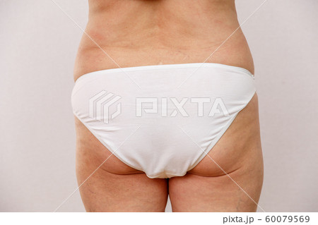 Elderly woman in white panties shows cellulite and 60079569