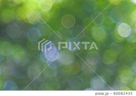 Green bio background, abstract blurred foliage bright sunlight. Organic design nature abstract background with copyspace for text advertising design. Green abstract light background and bokeh effect 60082435