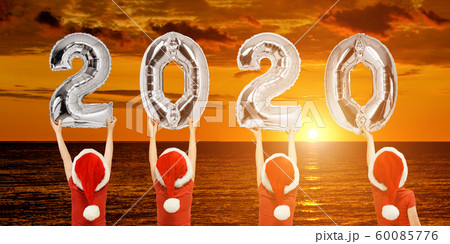 Number 2020 of shiny balloons in hands of boys in Number 2020 of shiny balloons in hands of boys in 60085776