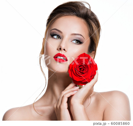 Closeup face of beautiful woman with red rose Closeup face of beautiful woman with red rose 60085860