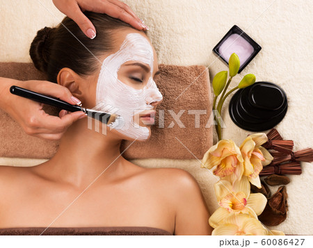 Woman having a facial cosmetic mask at spa salon. Woman having a facial cosmetic mask at spa salon. 60086427