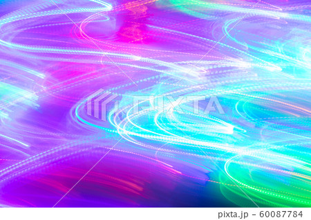 Turquoise-green-pink glowing background of lot of bright wavy neon lines as backdrop or wallpapers. Abstract  luminous background. Photographic effect of long exposure. 60087784