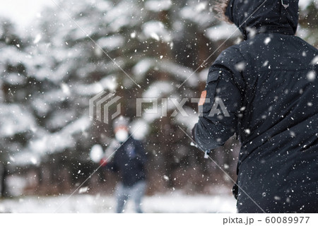 Young Happy friends enjoying throwing Snow balls, Having Fun in a Snowy Mountain. Young Happy friends enjoying throwing Snow balls, Having Fun in a Snowy Mountain. 60089977