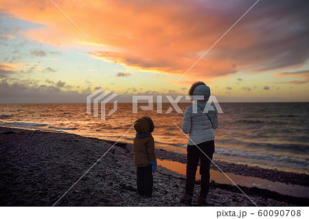 Woman wearing white jacket and little child are Woman wearing white jacket and little child are 60090708