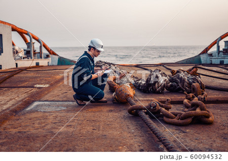 Marine chief officer or chief mate on deck of ship or vessel. He fills up ahts vessel checklist 60094532