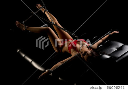 Female in red lingerie fixed with bdsm chain shot 60096241