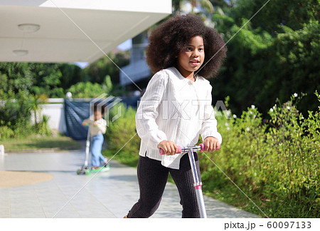 Little girl riding and playing scooter and have fun in the holiday activities in home.	 60097133