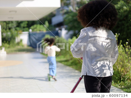 Little girl riding and playing scooter and have fun in the holiday activities in home.	 60097134