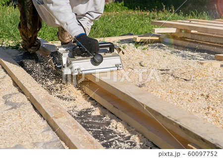 man planing boards with electric tools, chips flying in all directions man planing boards with electric tools, chips flying in all directions 60097752
