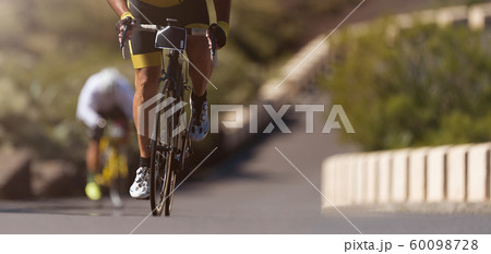 Cycling competition,cyclist athletes riding a race,climbing up a hill on a bicycle 60098728