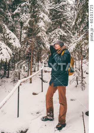 Full-length photo of man in winter forest. 60101725