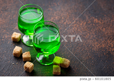 Glasses of absinthe with brown sugar Glasses of absinthe with brown sugar 60101805