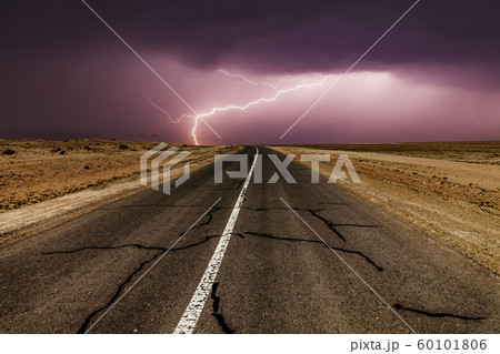 Stormy country road at night, with intense lightning strikes. Stormy country road at night, with intense lightning strikes. 60101806