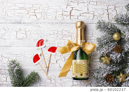 Bottle of champagne in a gold wrapper 60102237