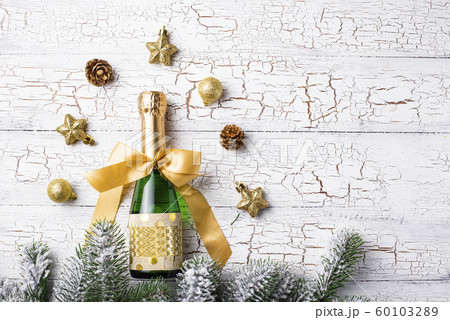 Bottle of champagne in a gold wrapper Bottle of champagne in a gold wrapper 60103289