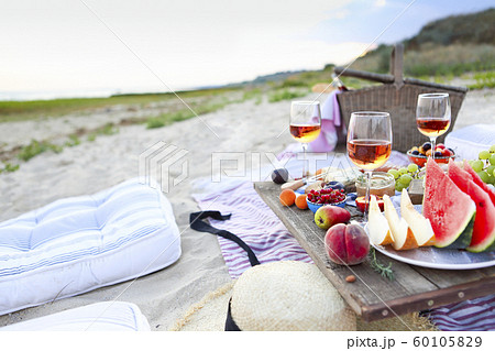 Picnic on the beach at sunset in the style of boho Picnic on the beach at sunset in the style of boho 60105829