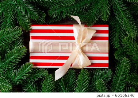 Top view of Christmas gift box on fir tree 60106246