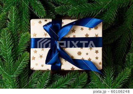 Top view of New Year gift box decorated with fir Top view of New Year gift box decorated with fir 60106248