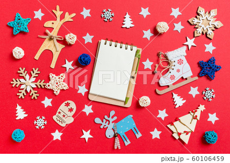 Top view of notebook, holiday toys and decorations 60106459