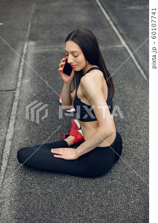 Sports girl training at the stadium 60107741