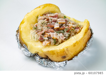 Photo of baked potato with bacon filling on white background 60107985