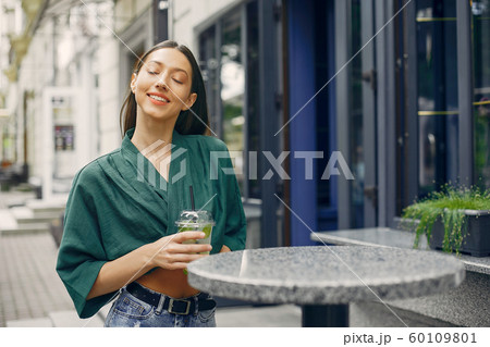 Fashion girl standing in a summer city 60109801
