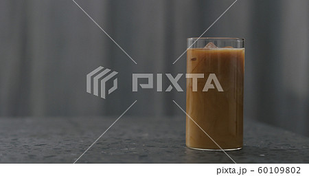 iced coffee with milk on terrazzo countertop 60109802