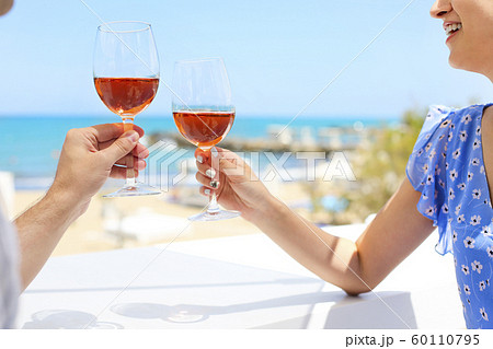 Hands of couple enjoying glasses of rose wine on 60110795