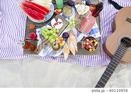 Picnic on the beach at sunset in the style of boho Picnic on the beach at sunset in the style of boho 60110958